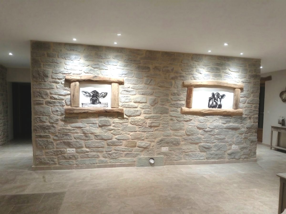 Mur intérieur en pierre nettoyé et rejointoyé à la chaux, avec deux niches à linteaux en bois